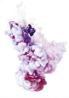 pink and white ink in water on a white background, with the color purple added to it