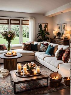 a living room filled with lots of furniture next to a large window covered in candles