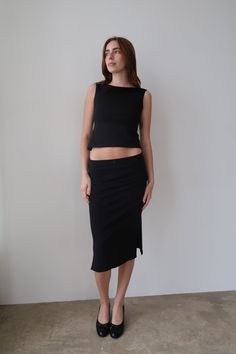 HERR BY ISABELA DEMI MIDI SKIRT Low/mid-rise black midi skirt with two slits on each side and a black mini ribbon bow. Responsibly made in Los Angeles, CA. DETAILS 95% cotton 5% spandex care instructions- machine wash in cold water, tumble dry low, no bleach Kaylee is wearing size xs If you are in between sizes, we recommend sizing down. See size guide for sizing information 90s Minimalism Fashion, Black Midi Skirt Outfit, 90s Midi Skirt, Black Skirt Outfits, Skirt Aesthetic, Midi Skirt Outfit, Outfit 90s, Black Midi Skirt, Black Midi