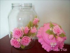 two glass jars with pink flowers in them