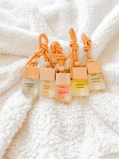 five small wooden cubes sitting on top of a white blanket next to each other