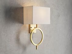 a wall light with a white square shade on it's side against a gray wall