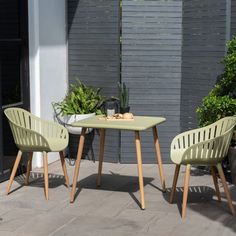 two chairs and a table on a patio