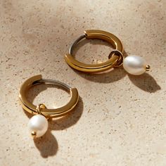 Elevate your style with our Chic Pearl Hoop Earrings. The fusion of pearls and hoops brings modern elegance to new heights. Adorn yourself with this sophisticated charm. Metal: 14K Gold Vermeil Length: 19.8 mm / 0.8" Hoop Diameter: 13.3 mm / 0.5" Thickness: 1.6 mm / 0.62" Gemstone: Pearl Weight: 0.8 g Minimalist Yellow Gold Hoop Earrings With Pearl Charm, Modern Hoop Jewelry With Pearl Charm, Modern Gold Hoop Earrings With Pearl Charm, Modern Yellow Gold Hoop Earrings With Pearl Drop, Modern Small Hoop Earrings With Pearl Drop, Modern Small Hoop Pearl Drop Earrings, Modern Hoop Earrings With Pearl Charm, Modern Yellow Gold Hoop Pearl Earrings, Modern Yellow Gold Pearl Hoop Earrings