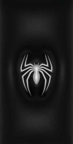 a black and white spider logo on a dark background