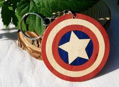 the captain's shield keychain is made out of wood and has a star on it