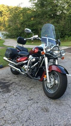 a red and black motorcycle parked in a parking lot