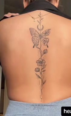 a woman's back with flowers and butterflies on it