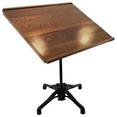 a wooden table with black metal legs on a white background