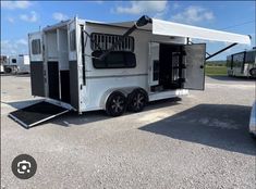 a white horse trailer parked in a parking lot