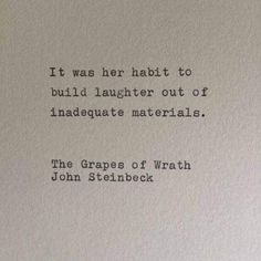 an old typewriter with the words it was her habit to build laughter out of inadequate materials