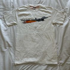 a white t - shirt with an airplane painted on it