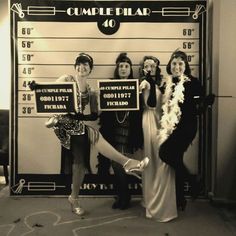 some women are posing for a photo in front of a police mugshot sign that says,