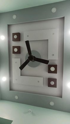 a square clock is mounted to the wall