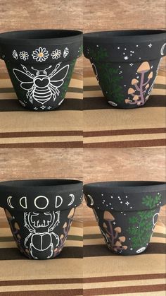 three black pots with designs on them sitting on a striped tablecloth, one has a bee and the other has flowers