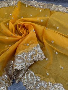 an image of a yellow cloth with gold sequins