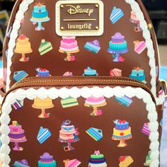 Super Awesome Loungefly Disney Princesses Wedding Cake Dress Great Backpack Design. This Is A Fun Summertime Bag. It Has A Large Zipper Compartment And A Smaller Zipper Compartment On The Front With Adjustable Leather Straps. Great For Everyday Use. Disney Style Brown Backpack For Disney Trips, Brown Disney Backpack, Loungefly Disney Backpack, Princess Wedding Cakes, Disney Backpack, Disney Princess Wedding, Backpack Design, Cake Dress, Wedding Dress Cake