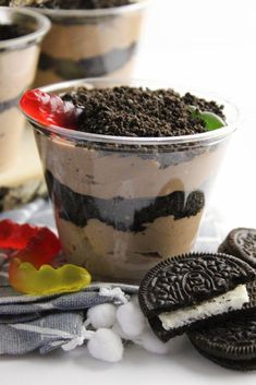 an oreo cookie dessert in a plastic cup with ice cream and cookies around it