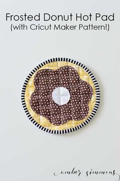 a paper plate with a polka dot design on it and the words frosted donut hot pad