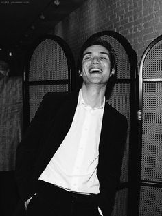 a black and white photo of a man laughing