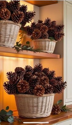 some pine cones are in a basket on a shelf next to other pine cones and greenery