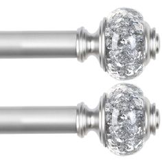 two metal handles with crystal knobs on them