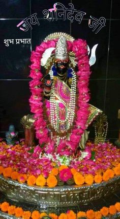 the statue is decorated with flowers and garlands