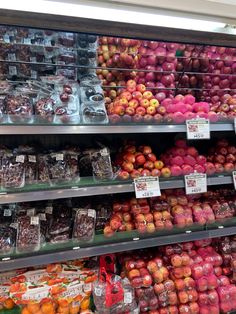 an assortment of fruits and vegetables on display in a grocery store