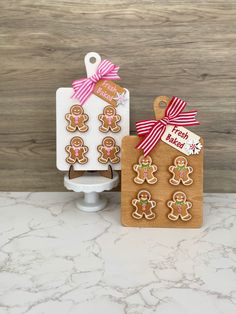 gingerbread cutouts are on display next to a cookie board with tags and bows