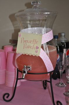 a pink table topped with lots of drinks