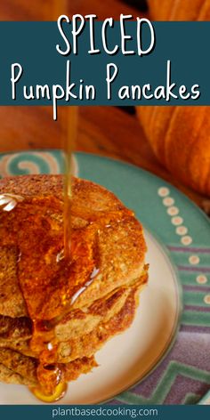 a stack of pancakes with syrup being poured on top