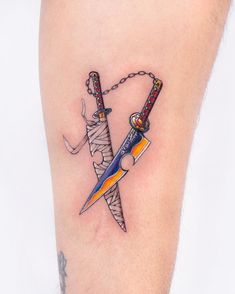 a tattoo on the leg of a person holding two swords