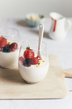 two glasses filled with yogurt and berries