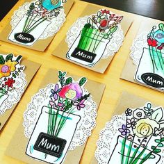 four cards with flowers in vases on them and lace doily around the edges