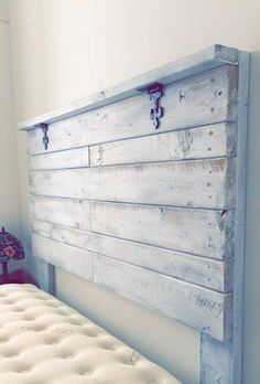 the headboard is made from an old wooden plank