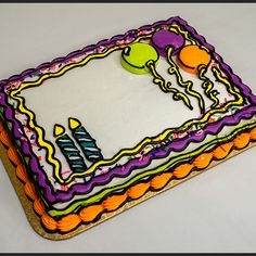 a birthday cake with candles and balloons on it