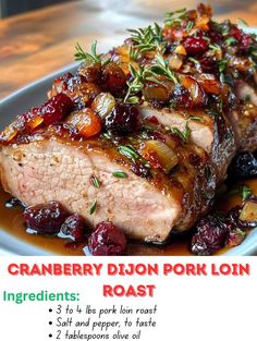 a close up of meat on a plate with cranberry dijon pork loin