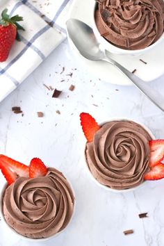 two desserts with chocolate frosting and strawberries