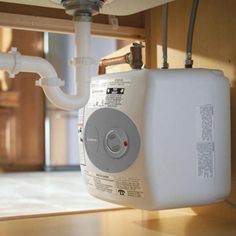 a water heater sitting on top of a wooden table