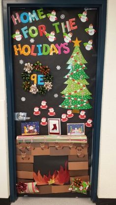 a door decorated with christmas decorations and writing on the front, as well as a fireplace