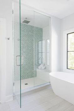 a white bath tub sitting next to a window