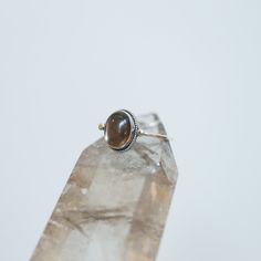 Sometimes you want to gaze down at your ring and see perfect balance and grace. That's what this Dainty Smoky Quartz Delica Ring has to offer. High-grade smoky quartz stone with a simple, sterling silver design. Perfect little ring. Lovely, traditional, dainty ring of 10X12 mm Smoky quartz cabochon set in .925 sterling silver oxidized and burnished bezel and wire. Simple, elegant and perfect. This lovely, translucent, and sparkling warm, taupe grey-colored ring is created using traditional silve Spiritual Nickel-free Rings For Everyday, Spiritual Birthstone Rings For Everyday, Everyday Spiritual Birthstone Rings, Spiritual Birthstone Rings, Spiritual Sterling Silver Stackable Promise Rings, Spiritual Sterling Silver Opal Ring, Sterling Silver Spiritual Opal Ring, Minimalist Amber Ring Jewelry, Spiritual Sterling Silver Opal Ring For Healing