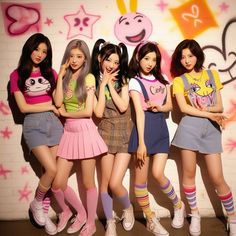 the girls are posing in front of a wall with pink and yellow graffiti on it