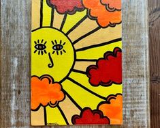 a painting of a sun with clouds in the sky on a wooden background, painted by children