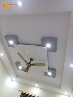 a ceiling with some lights and a fan