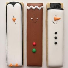 three decorated cookies in the shape of snowmen