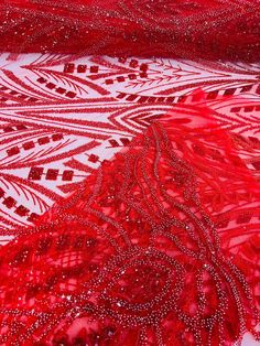 red and white fabric with beads on it