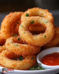 fried onion rings on a plate with dipping sauce