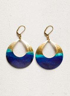 Hammered brass hoops are accented with a natural verdigris patina and splashed with indigo pigment. Gold-plated leverbacks. Nickel and lead free.2.5“ [6.25 cm] long. Blue Teardrop Jewelry With Patina, Blue Teardrop Patina Jewelry, Artsy Blue Metal Jewelry, Hand Forged Blue Round Earrings, Blue Teardrop Earrings With Patina, Artisan Blue Hoop Earrings Nickel Free, Artisan Blue Brass Earrings, Blue Metal Jewelry With Patina, Blue Hoop Brass Jewelry