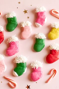 christmas cookies decorated with candy canes and stocking on a pink background, top view